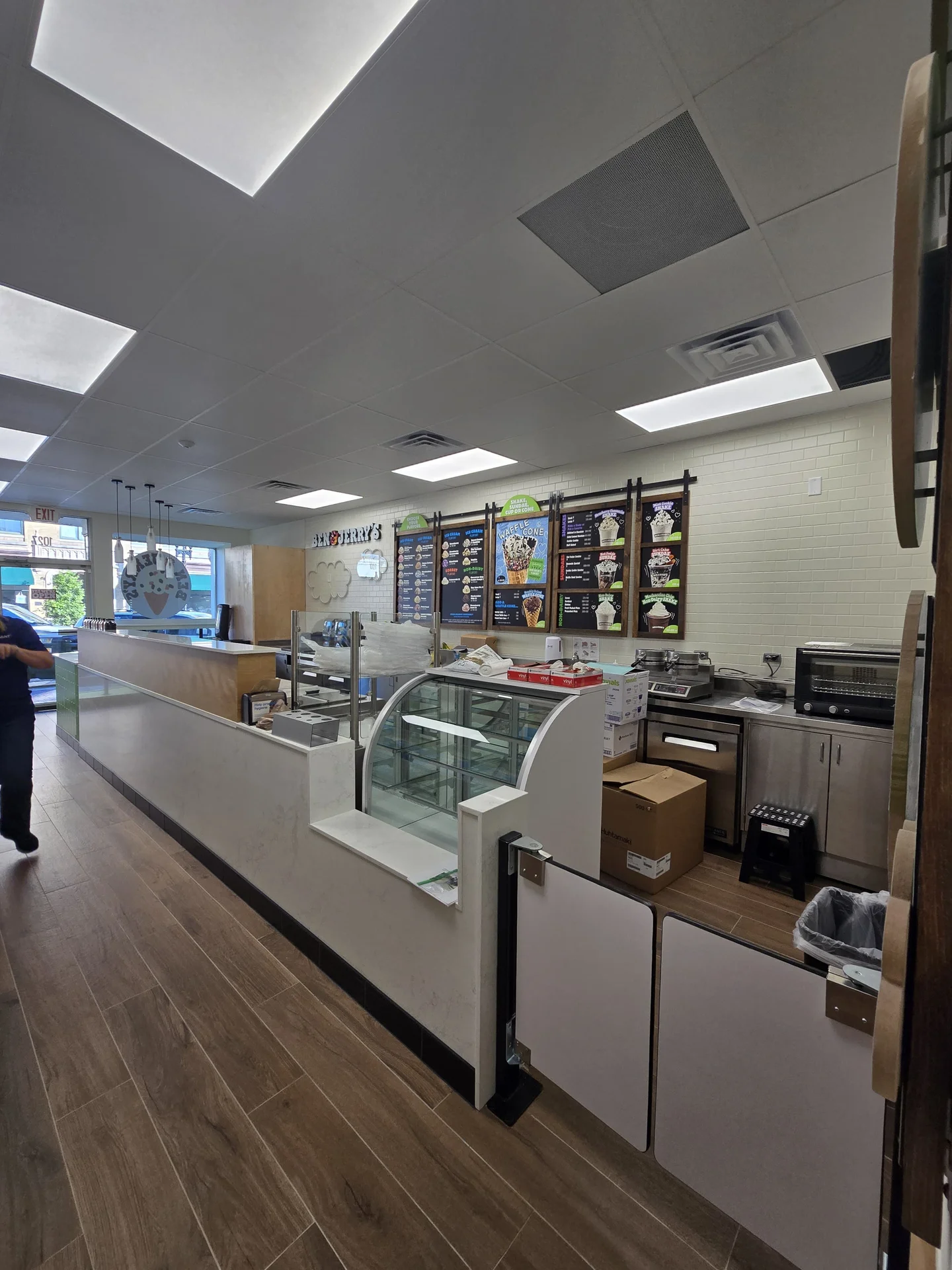 Finished commercial interior buildout with service counter, glass display case, and menu boards